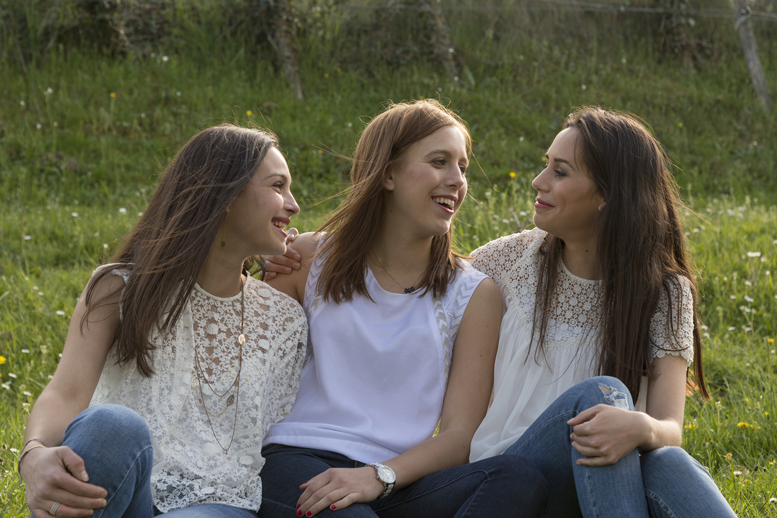 Portrait de trois jeunes femmes vetues de blanc en exterieur